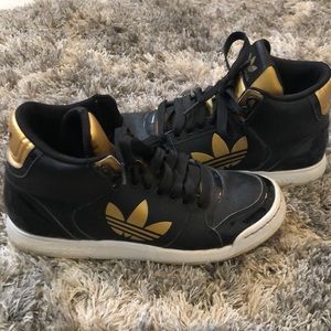 Black and gold adidas sneakers